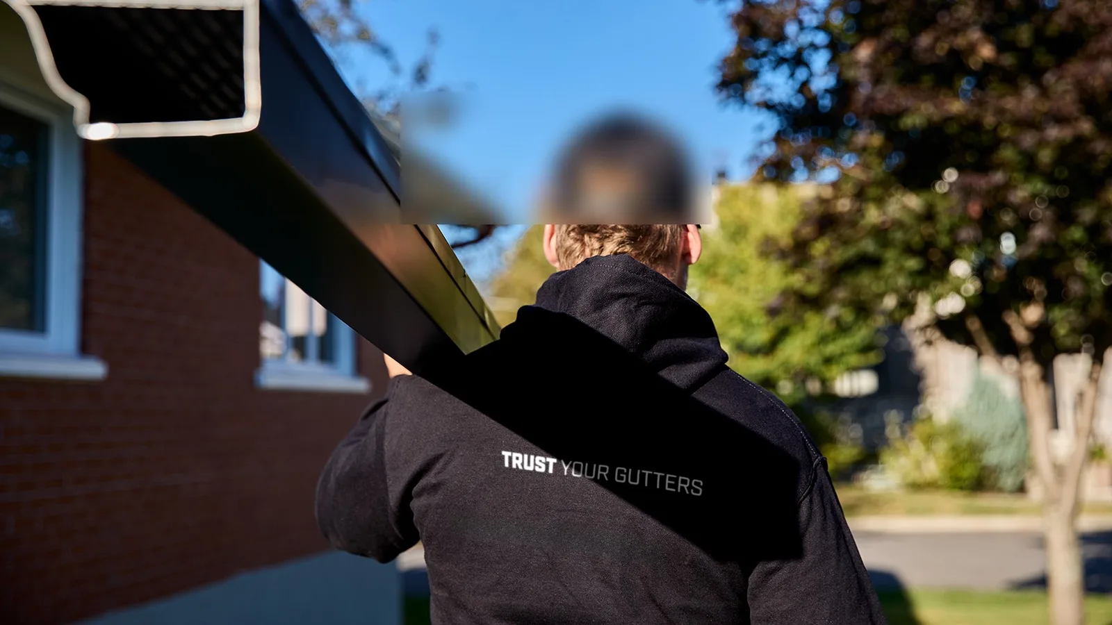 Crew preparing seamless gutters for installation on Central Vancouver Island